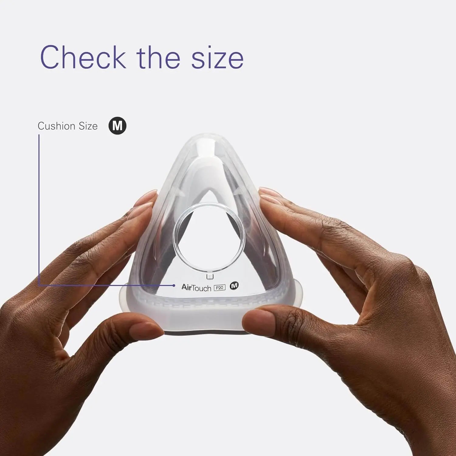 ResMed AirTouch F20 medium cushion being held, showcasing the size check feature for precise fit and comfort.