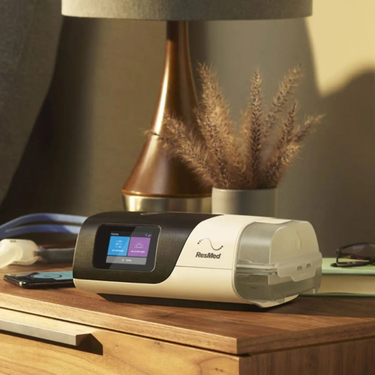 ResMed AirSense 11 AutoSet CPAP Machine with humidifier in a bedroom